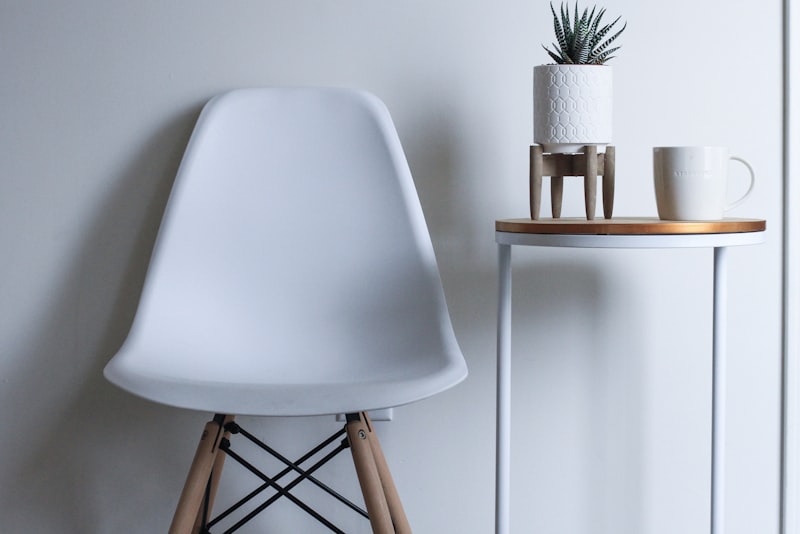 A cozy living room corner lit by a floor lamp and a small table lamp in the evening