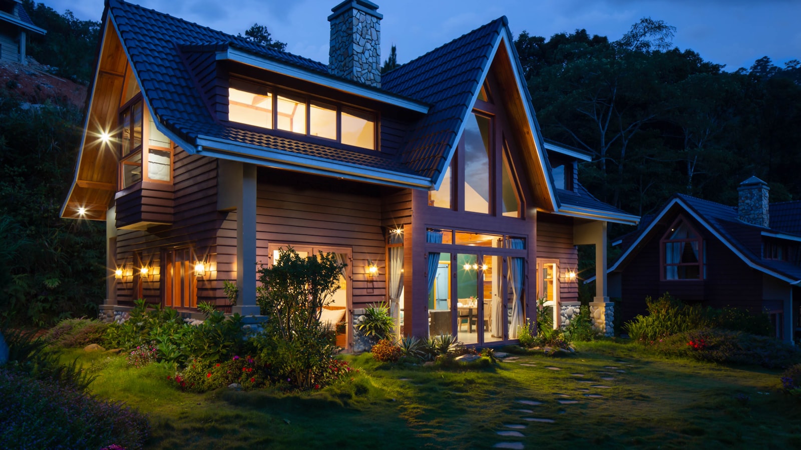 A welcoming front entrance with a painted door, potted plants, and clear house numbers