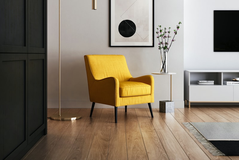 A warmly styled living room corner with a textured throw, a plant, and a thrifted accent chair