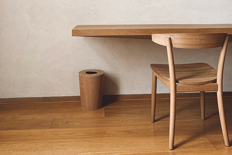 A compact, well-organized apartment corner with wall shelves and a storage bench